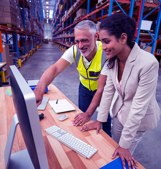 Profesionales revisando el inventario y la gestión de pedidos en un gran almacén industrial